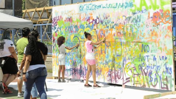kids spray painting wall