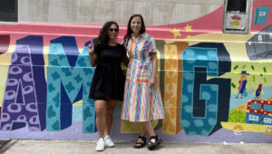 Teaching artists pose in front of mural