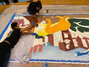 Students in process on the mural