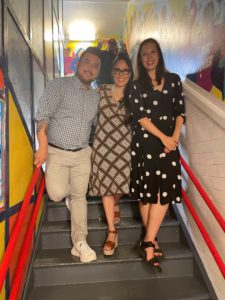 Artists pose with principal on stairwell